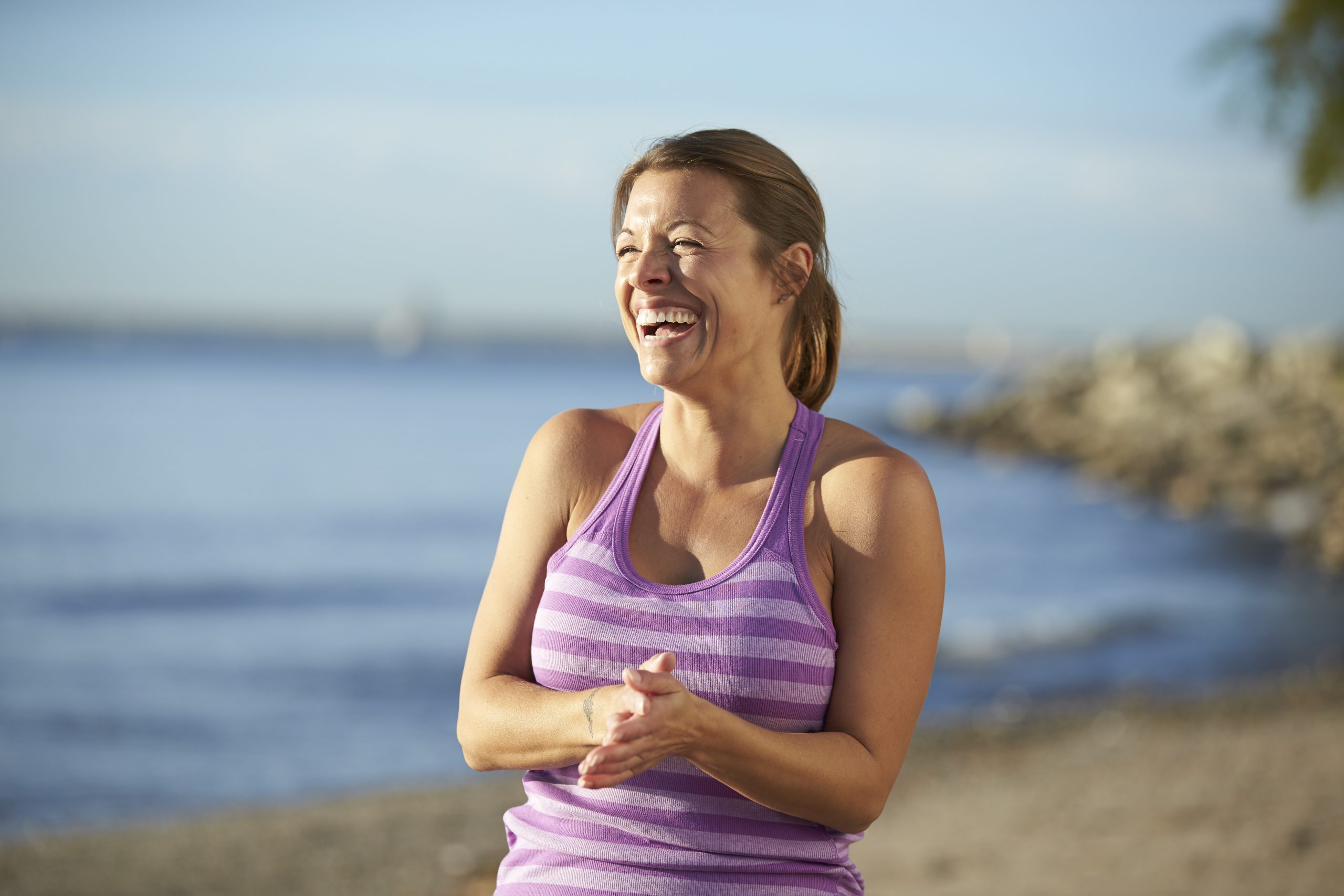 Woman laughing at the beach