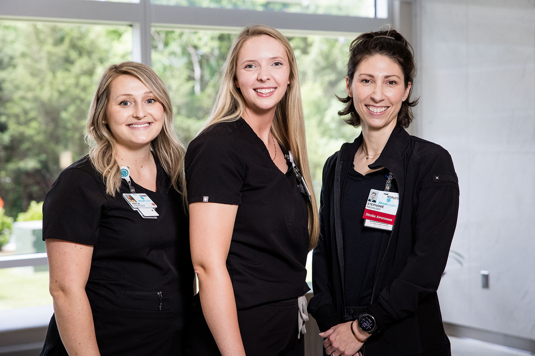 group of three female staff in black scrubs