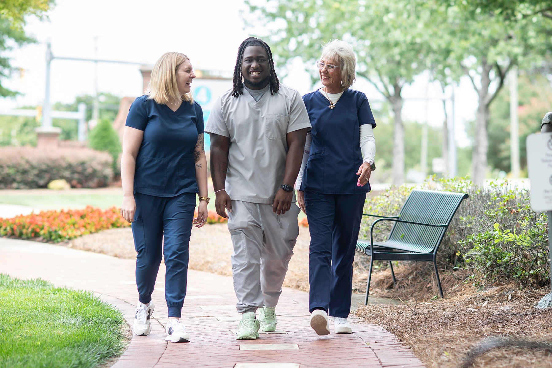 Three staff walking together outside