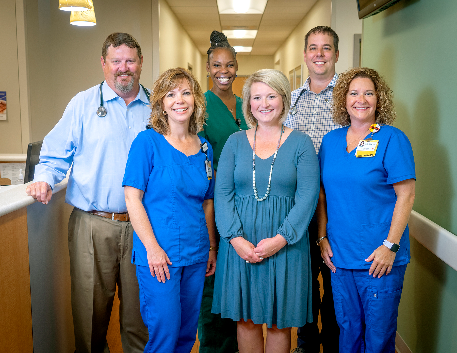 Group of six staff in a clinical setting