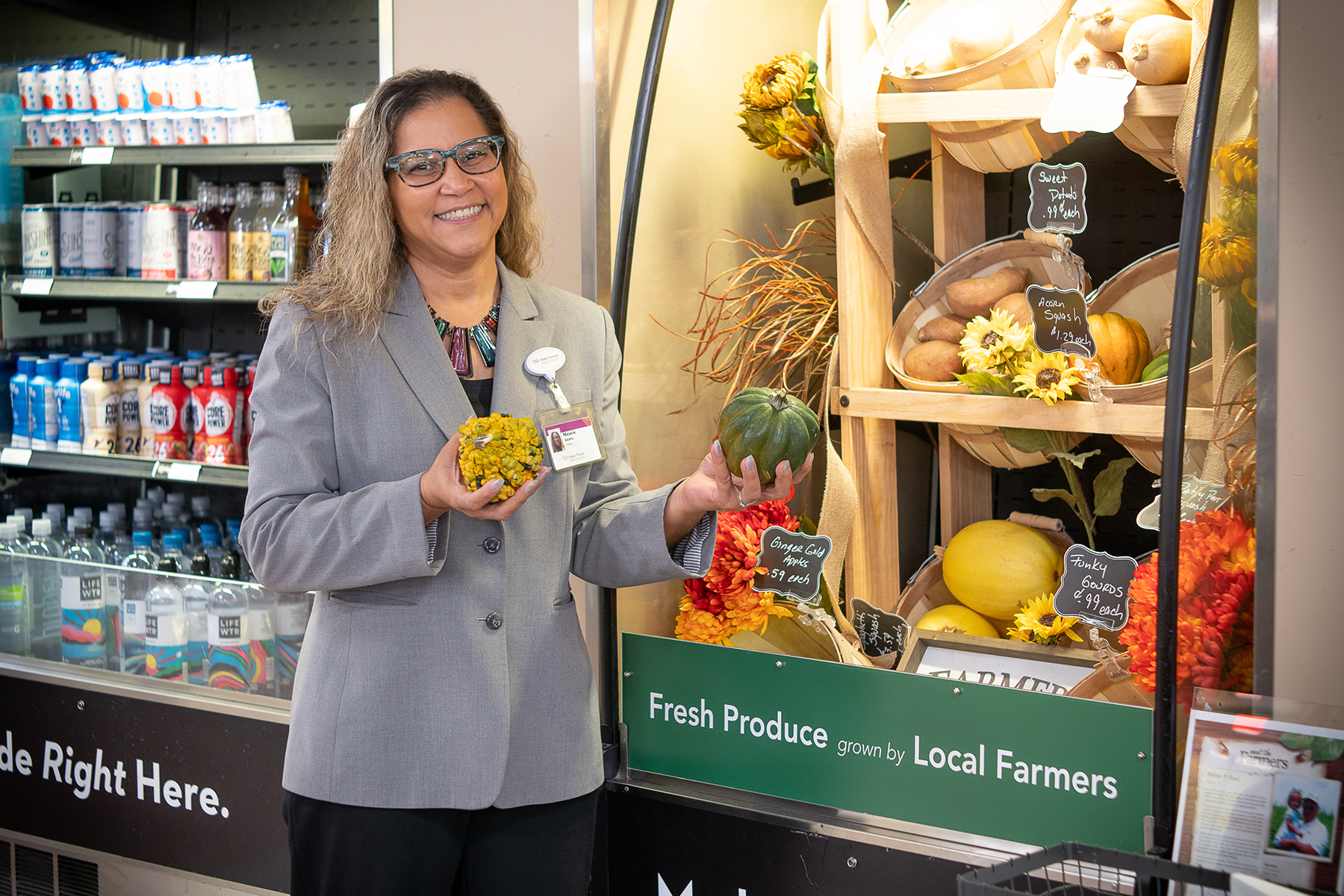 Female holding fresh produce outside of grab and go